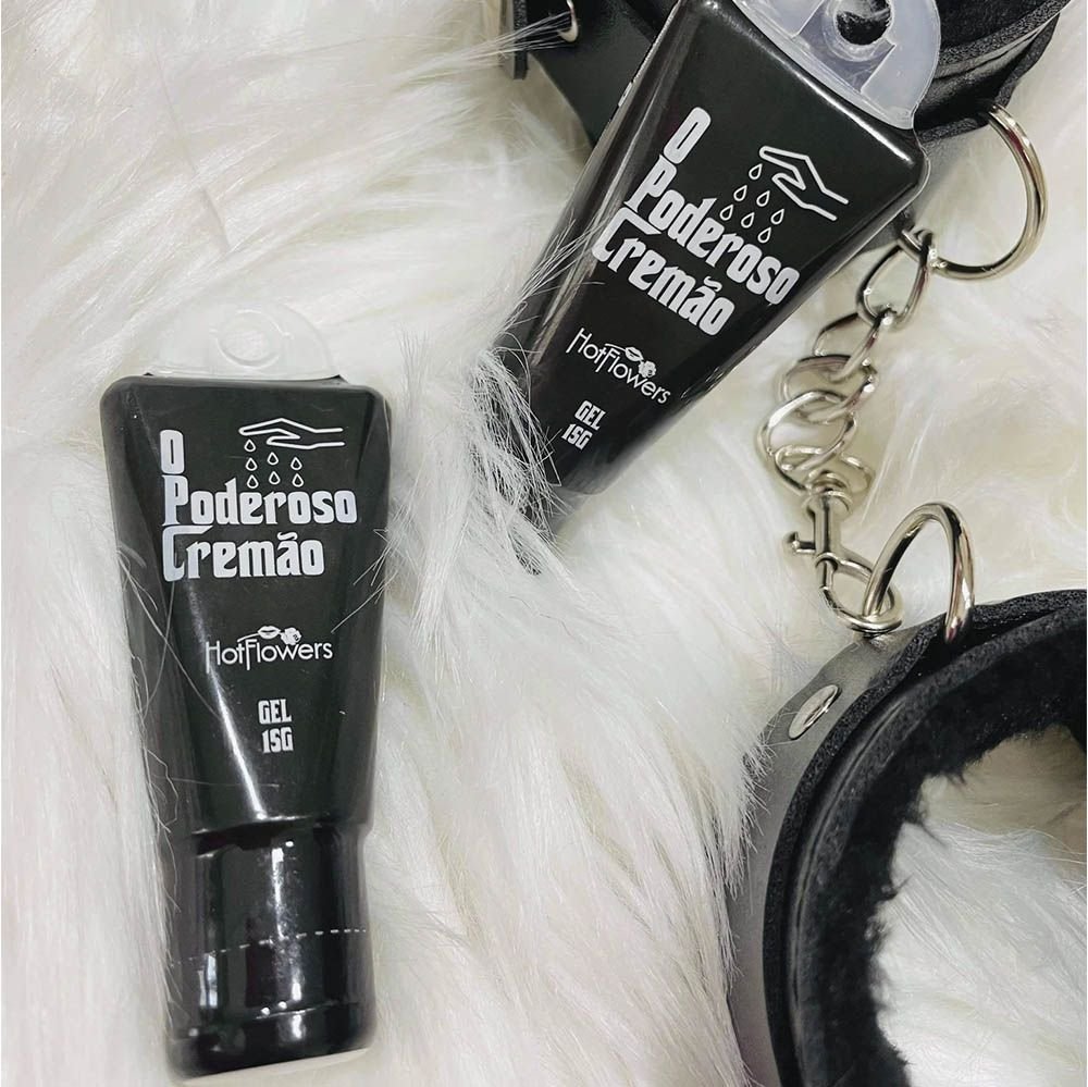 Excitante Unissex O Poderoso Crem�o 15ml ao lado de algemas, sugerindo uso em momentos de intimidade