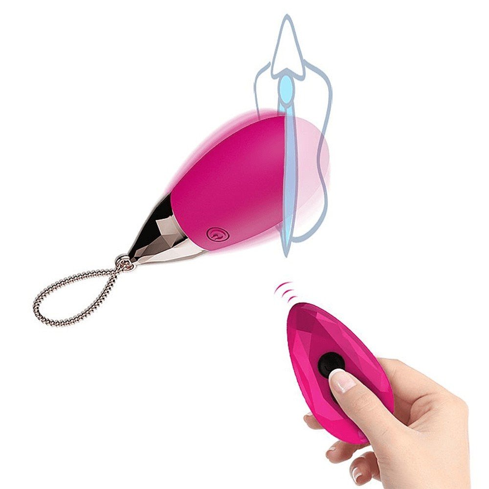 Vibrador para Cl�toris em Silicone Recarreg�vel Multivelocidade Controle sem Fio Pink, mostrando o vibrador em formato de gota e o controle remoto com design facetado, ambos na cor pink com detalhes dourados.