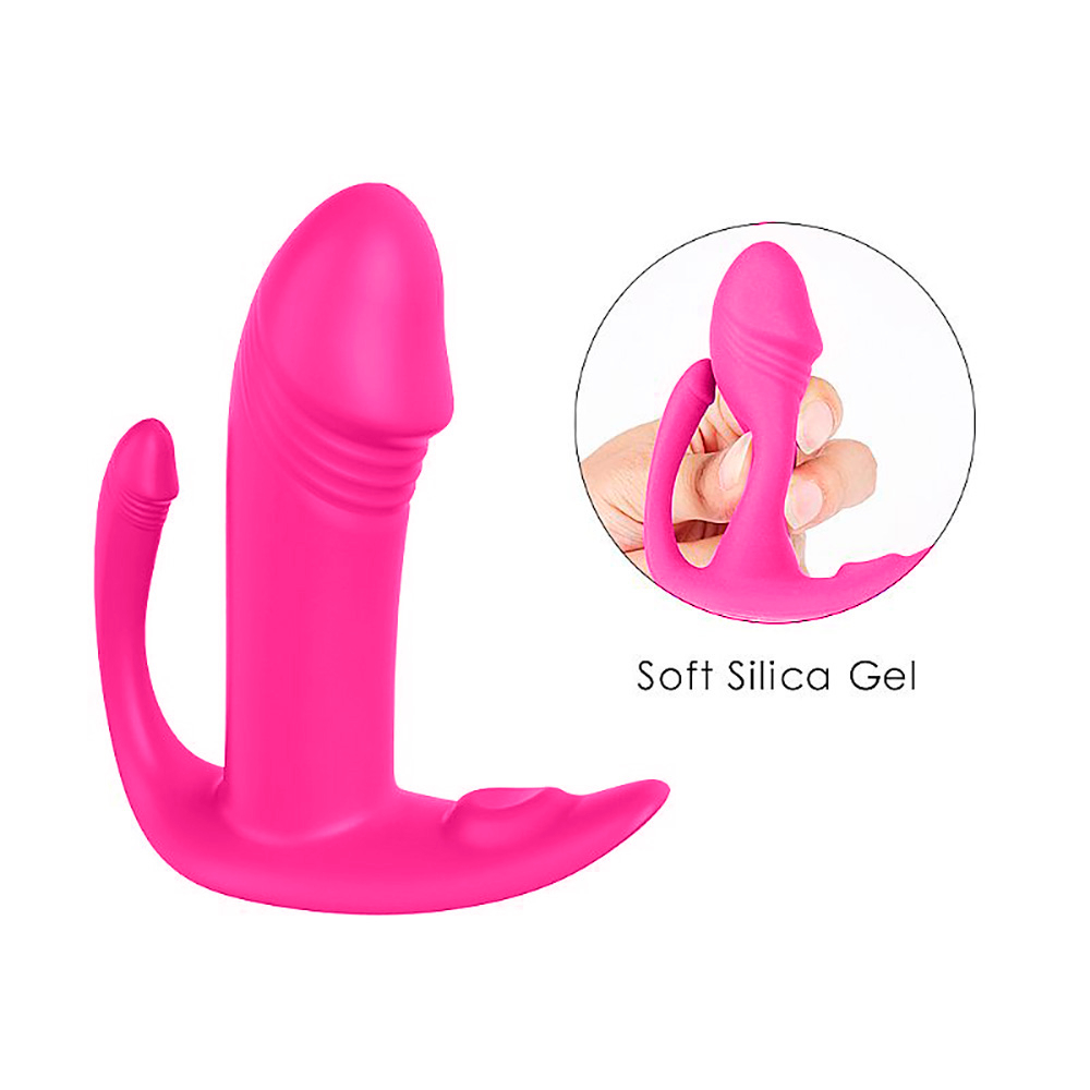 Vibrador Duplo Didi Pink em silicone com um dos bra�os sendo pressionado, destacando a maleabilidade do material.